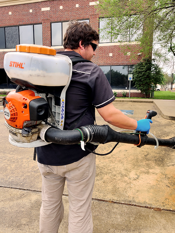 A Bulls Eye technician applying a mosquito barrier fogging treatment